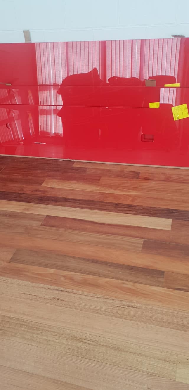 Glass splashback back sprayed in a high-gloss red for a Tasmanian kitchen