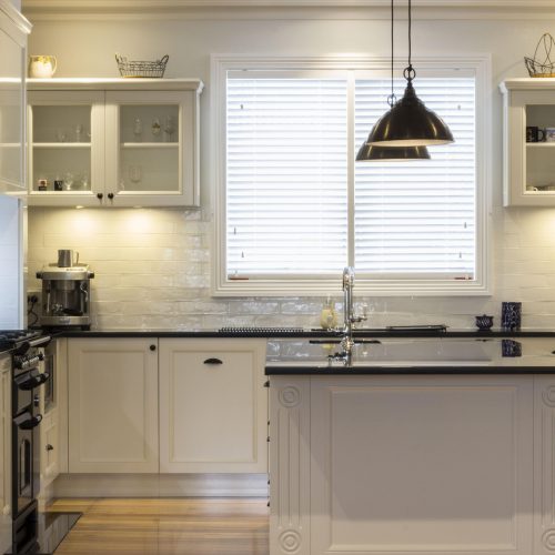 Sprayed overhead cabinetry and glazed display doors in the same Cygnet kitchen