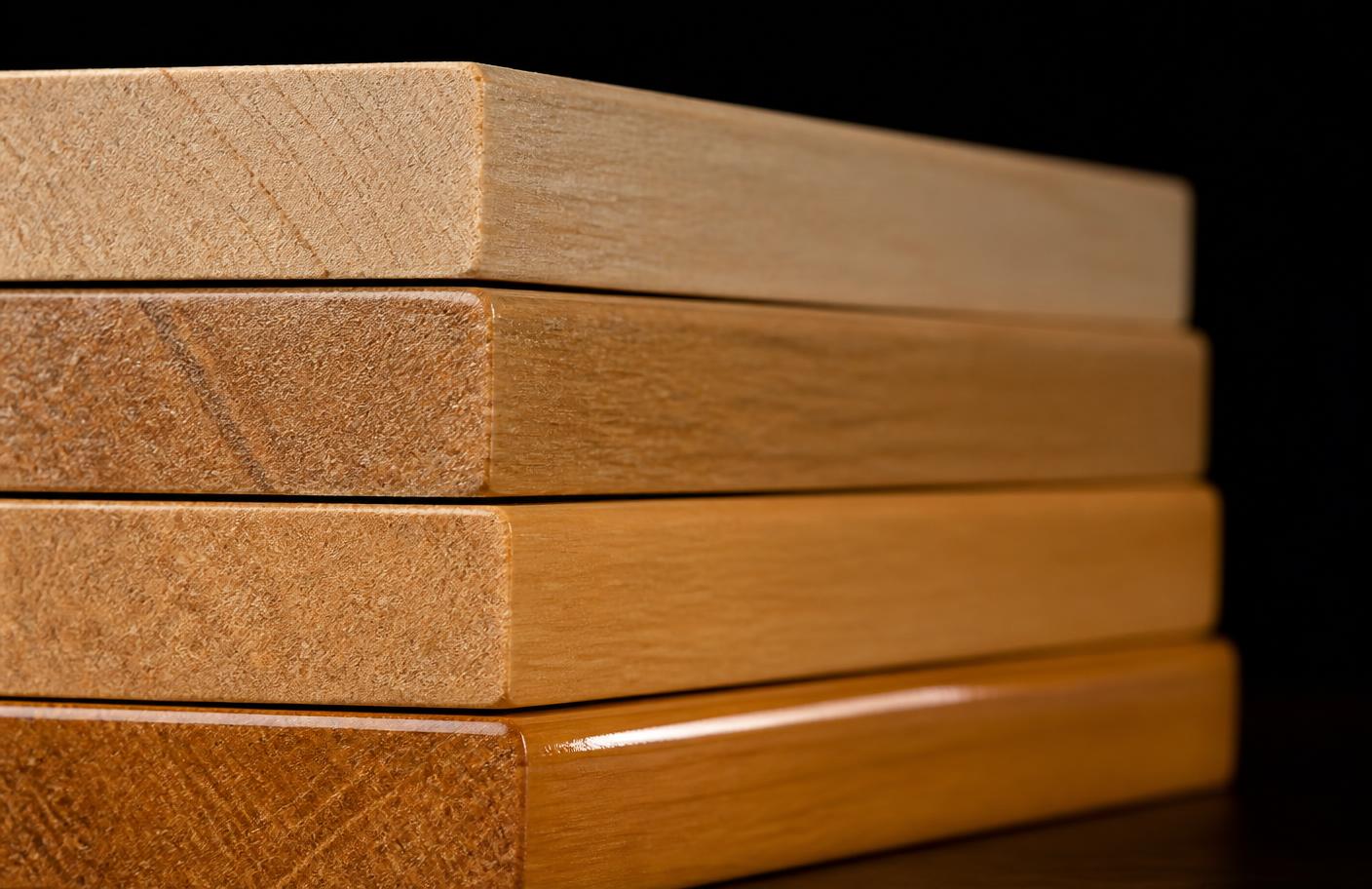 Coated timber sample offcuts stacked edge-on showing each stage of finish