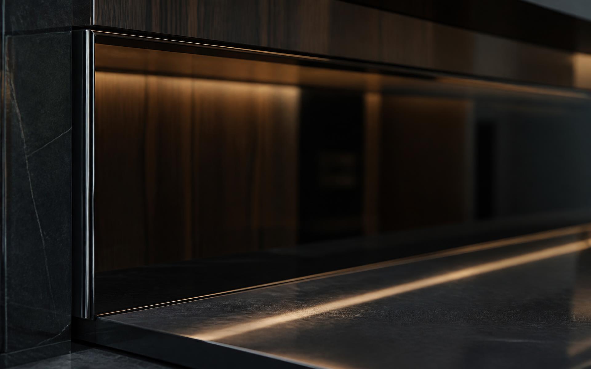 Close-up of a colour-matched glass splashback behind a kitchen benchtop in Hobart